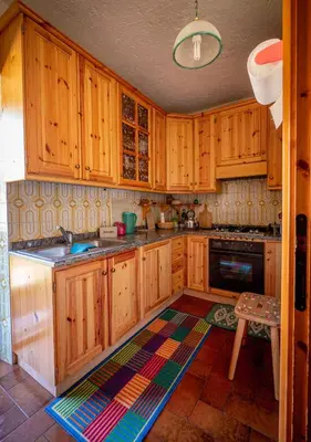 a living room with chairs and a couch and a tv at Chalet della Civetta in Pianaz