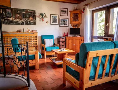 an overhead view of a living room with blue furniture at Chalet della Civetta in Pianaz