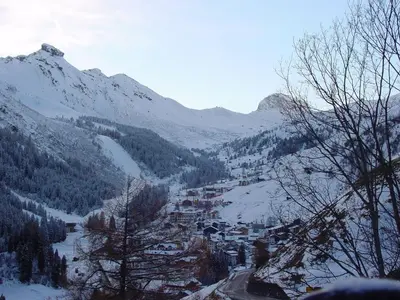 a mountain valley with a town in the snow at Appartamenti Dany in Arabba