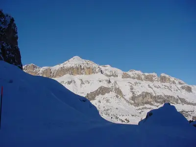 a mountain covered in snow with a blue sky at Appartamenti Dany in Arabba