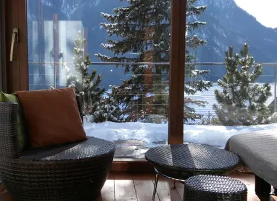 a room with a window with a view of snow covered trees at Apartments Markus in Ortisei