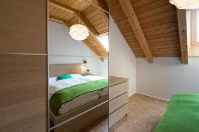 a bedroom with a bed and a wooden ceiling at Apartments Markus in Ortisei