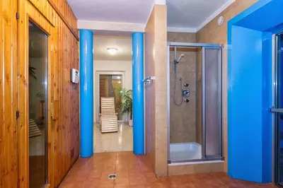 a bathroom with blue columns and a shower at Apartments Markus in Ortisei