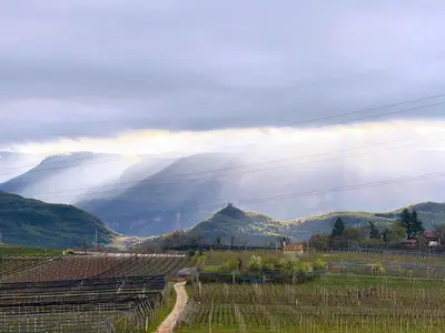 a view of a field with mountains in the background at Weitblick Apartment mit Garten in Castelvecchio