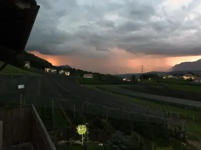 a view of a vineyard at sunset with a cloudy sky at Weitblick Apartment mit Garten in Castelvecchio