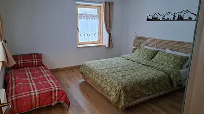 a bedroom with a bed and a window at Staguda 59 in Sottoguda