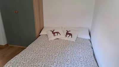 a small bed with two pillows on top of it at Staguda 59 in Sottoguda