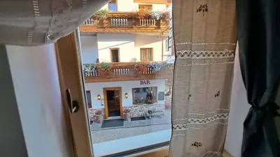 a window view of a building with a balcony at Staguda 59 in Sottoguda