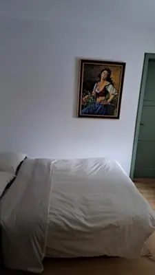 a white bed in a room with a picture on the wall at Staguda 59 in Sottoguda