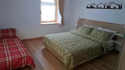 a bedroom with a bed and a window at Staguda 59 in Sottoguda