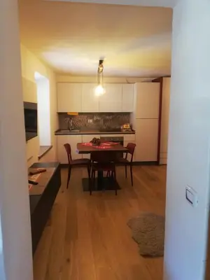 a kitchen and dining room with a table and chairs at Monolocale Fiera di Primiero in Fiera di Primiero