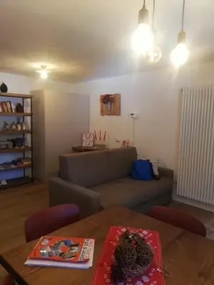 a living room with a couch and a table at Monolocale Fiera di Primiero in Fiera di Primiero
