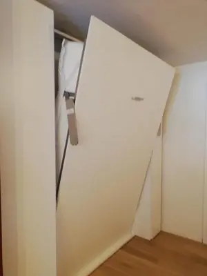 a room with a white wall and a white closet at Monolocale Fiera di Primiero in Fiera di Primiero