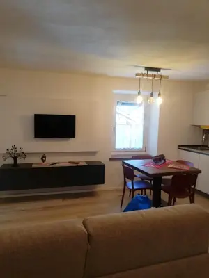a living room with a couch and a table at Monolocale Fiera di Primiero in Fiera di Primiero