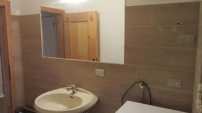 a bathroom with a sink and a mirror at Baita cavalese giardino esclusivo in Cavalese
