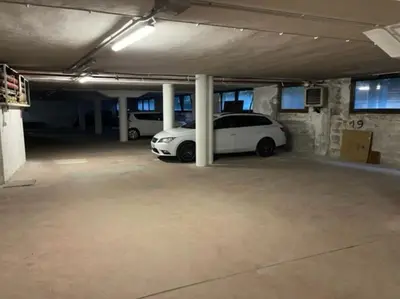 a white car parked in a parking lot at Stella Alpina San Martino di Castrozza vista Pale in San Martino di Castrozza