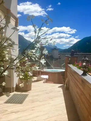 a balcony with a view of a body of water at Wellness Residence Panorama - check-in at Olympia Hotel in Arabba