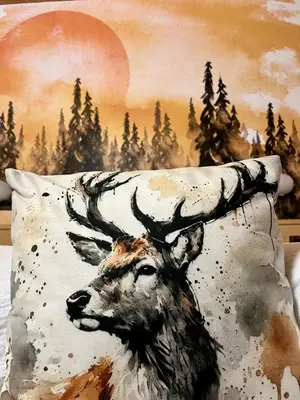 a painting of a deer with antlers on a pillow at Wellness Residence Panorama - check-in at Olympia Hotel in Arabba
