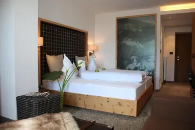 a bedroom with a large bed in a room at Hotel Patriarch in Tirolo
