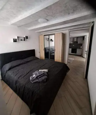 a bedroom with a black bed and a large window at Casa Jasmina in Mezzano
