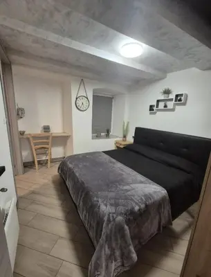 a bedroom with a large bed and a desk at Casa Jasmina in Mezzano