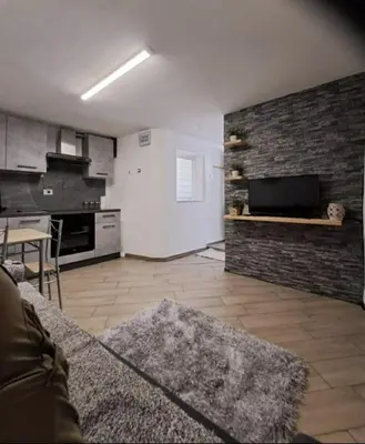 a living room with a couch and a kitchen at Casa Jasmina in Mezzano
