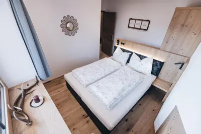 a small bedroom with a bed in a room at Flaschtal-Hof in Nova Ponente