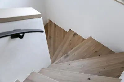 a wooden staircase in a room with a wooden floor at Schattmair Hof in Tirolo