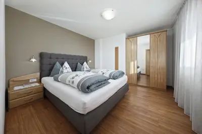 a bedroom with a bed with pillows on it at Schattmair Hof in Tirolo