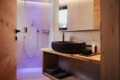 a bathroom with a sink and a shower at Luxury Chalet P in Ortisei