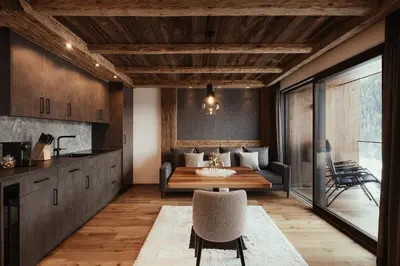 a living room with a bed and a table at Luxury Chalet P in Ortisei