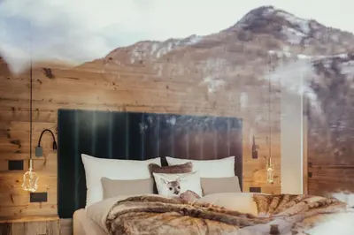 a bedroom with a bed with a mountain mural at Luxury Chalet P in Ortisei