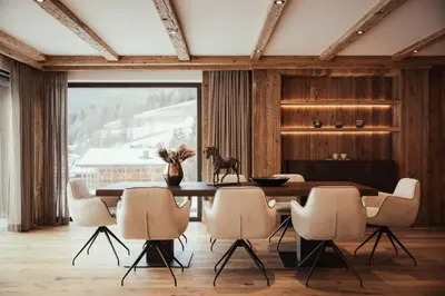 a dining room with a table and chairs at Luxury Chalet P in Ortisei