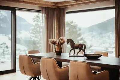 a wooden horse statue on a table in a dining room at Luxury Chalet P in Ortisei