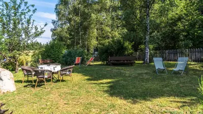 a group of chairs and a table in a yard at Residence Lärchenhäusl in Soprabolzano