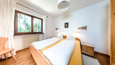 a bedroom with a bed and a window at Residence Lärchenhäusl in Soprabolzano
