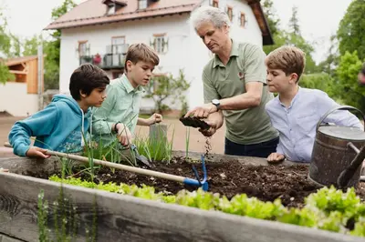 a group of children and an older man in a garden at Haus Himmelfahrt in Soprabolzano