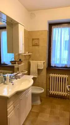 a bathroom with a sink and a toilet at Appartamento Casa Serena in Siror