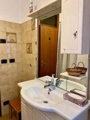 a bathroom with a sink and a mirror at Appartamento Casa Serena in Siror