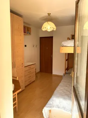 a bedroom with a bunk bed and a desk at Appartamento Casa Serena in Siror