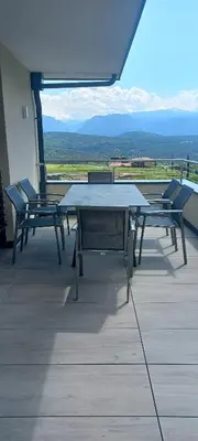 a table and chairs on a balcony with a view at Haus Bonell in Pianizza di Sopra