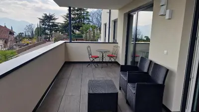 a balcony with chairs and a table on a building at Haus Bonell in Pianizza di Sopra