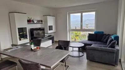 a living room with a table and a couch at Haus Bonell in Pianizza di Sopra