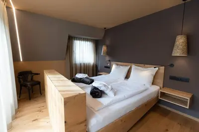 a bedroom with two beds with towels on them at Traumhaftes Panorama und Wohlfühl-Wellness im Penthouse St. Helena in Partschins in Parcines