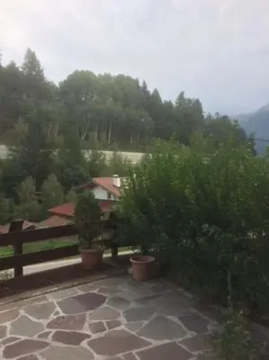 a view of a garden with trees and a fence at BIS Vipiteno in Vipiteno
