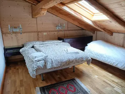 a bedroom with two beds in a attic at Resort CuraLibera in Ronzone