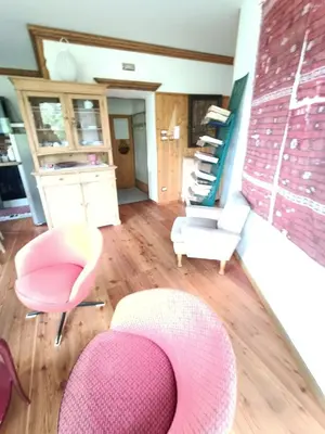 a living room with two chairs and a pink chair at Resort CuraLibera in Ronzone