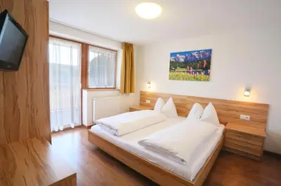 a bedroom with a bed and a tv in it at Apartment Pichlerhof in San Lorenzo di Sebato