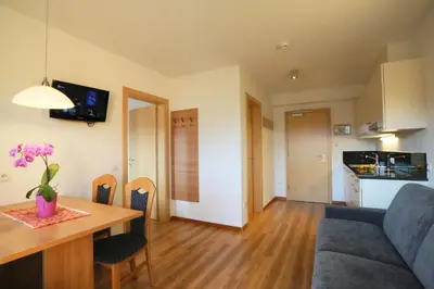 a living room and kitchen with a table and a couch at Apartment Pichlerhof in San Lorenzo di Sebato