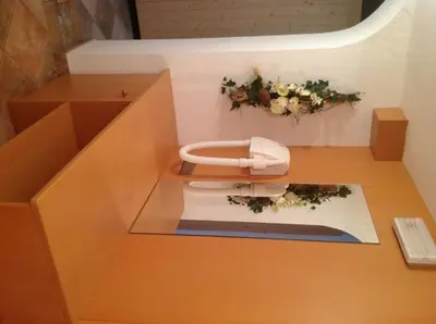 a model of a bathroom with a toilet with flowers at Garni Bergland in Racines